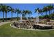 Circular fountain in Payne Park surrounded by palm trees and lush landscaping at 1990 Main St # 15, Sarasota, FL 34236