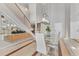 Modern dining area with glass table and white chairs near staircase at 1990 Main St # 15, Sarasota, FL 34236