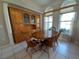 Round dining table with four chairs and built-in hutch at 201 Bayside Ct, Nokomis, FL 34275