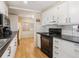 Bright kitchen boasts white cabinets and black countertops at 2107 Palma Sola Blvd # 94, Bradenton, FL 34209