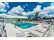 Community pool surrounded by ample seating and lush landscaping, perfect for relaxation at 2107 Palma Sola Blvd # 94, Bradenton, FL 34209
