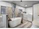 Bathroom with a soaking tub, shower, and laundry at 2107 Palma Sola Blvd # 94, Bradenton, FL 34209