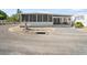 Mobile home with screened porch and gravel driveway at 2107 Palma Sola Blvd # 94, Bradenton, FL 34209