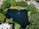 Arial view of community lake, landscaping, and building at 315 30Th W Ave # B311, Bradenton, FL 34205