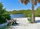 Peaceful waterfront scene with a rustic bench on a sandy beach at 315 30Th W Ave # B311, Bradenton, FL 34205