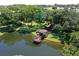 Aerial view of property includes lake, walking paths, gazebo, trees and benches at 315 30Th W Ave # B311, Bradenton, FL 34205