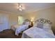 Comfortable bedroom featuring two beds, ceiling fan, and ensuite bathroom at 315 30Th W Ave # B311, Bradenton, FL 34205