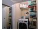 Bright laundry room features a newer front loading washer and dryer with shelving for storage of supplies at 315 30Th W Ave # B311, Bradenton, FL 34205
