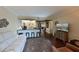 Open-concept living room with a bar-top kitchen area, and hardwood floors at 315 30Th W Ave # B311, Bradenton, FL 34205