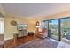 Cozy living room features a comfortable chair, TV, and sliding glass doors to the outside at 315 30Th W Ave # B311, Bradenton, FL 34205