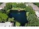 Aerial view of condo community featuring a serene lake and lush greenery at 315 30Th W Ave # B311, Bradenton, FL 34205