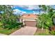 Single-story home with brown garage door and brick driveway at 335 River Enclave Ct, Bradenton, FL 34212