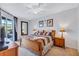 Spacious main bedroom with a king-size bed and access to a patio at 335 River Enclave Ct, Bradenton, FL 34212