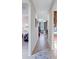 Bright hallway with tile flooring, offering a view into the living room and bedroom at 335 River Enclave Ct, Bradenton, FL 34212