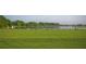 Scenic driving range overlooking a lake at 335 River Enclave Ct, Bradenton, FL 34212