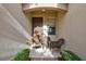 Charming front entry with a small sitting area and lush landscaping at 335 River Enclave Ct, Bradenton, FL 34212