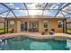Inviting pool area with covered patio, lounge chairs, and a tranquil atmosphere at 335 River Enclave Ct, Bradenton, FL 34212