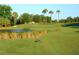 Picturesque golf course with water features and palm trees at 335 River Enclave Ct, Bradenton, FL 34212