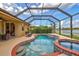 Beautiful pool and spa with screened enclosure, overlooking a lake at 335 River Enclave Ct, Bradenton, FL 34212