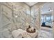 Luxurious shower with marble tile and glass enclosure at 4612 Stickley Ct, Palmetto, FL 34221