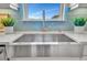 Farmhouse sink, quartz countertop, and a sleek gold faucet at 4612 Stickley Ct, Palmetto, FL 34221
