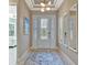 Light and airy entryway with decorative mirrors and rug at 4612 Stickley Ct, Palmetto, FL 34221