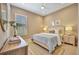Bedroom with queen-size bed, dresser, and window with plantation shutters at 4612 Stickley Ct, Palmetto, FL 34221