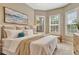 Main bedroom with a king-size bed and calming decor with natural light at 4612 Stickley Ct, Palmetto, FL 34221