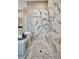 Large shower with marble tile and pebble floor at 4612 Stickley Ct, Palmetto, FL 34221