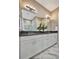 Double vanity with white cabinets and dark countertop at 4612 Stickley Ct, Palmetto, FL 34221