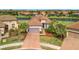 Single story home with a tile roof and a brick driveway, overlooking a lake at 4612 Stickley Ct, Palmetto, FL 34221
