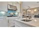 Bright kitchen with white cabinets, gas cooktop and breakfast bar at 4612 Stickley Ct, Palmetto, FL 34221