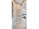Light and airy hallway with tile floors and a mirror at 4612 Stickley Ct, Palmetto, FL 34221