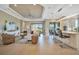 Spacious living room with hardwood floors, neutral decor, and sliding glass doors leading to the backyard at 4612 Stickley Ct, Palmetto, FL 34221