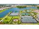 Aerial view of community tennis courts, playground, and pool at 4612 Stickley Ct, Palmetto, FL 34221