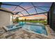 Inviting pool and spa with a covered patio and lake view at 4612 Stickley Ct, Palmetto, FL 34221