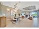 Bright dining room with modern chandelier and seating for six at 4612 Stickley Ct, Palmetto, FL 34221