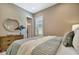 Bedroom with a queen bed, dresser, and window with plantation shutters at 4612 Stickley Ct, Palmetto, FL 34221