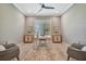 Home office with large window, two armchairs, and built-in cabinets at 4612 Stickley Ct, Palmetto, FL 34221