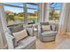 Bedroom sitting area with water views and comfy armchairs at 4612 Stickley Ct, Palmetto, FL 34221