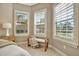 Bedroom corner with window seat and plantation shutters offering natural light at 4612 Stickley Ct, Palmetto, FL 34221