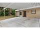 Carport and house entrance with tropical landscaping at 4773 Village Gardens Dr # 97, Sarasota, FL 34234