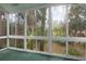 Screened porch with view of lush green backyard at 4773 Village Gardens Dr # 97, Sarasota, FL 34234