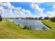 Peaceful lake view with houses and lush landscaping at 5262 Grove Mill Loop, Lakewood Ranch, FL 34211