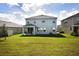 Two-story house with covered patio and green lawn at 5262 Grove Mill Loop, Lakewood Ranch, FL 34211