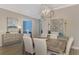 Elegant dining room with light wood table and statement wall decor at 5460 Lampiasi St, Sarasota, FL 34238