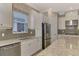 Kitchen with stainless steel appliances and grey backsplash at 5460 Lampiasi St, Sarasota, FL 34238