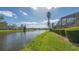 Peaceful canal-front view with lush landscaping at 5692 Country Lakes Dr, Sarasota, FL 34243