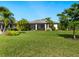 Spacious backyard with lush lawn and screened patio at 5951 Snowy Egret Dr, Sarasota, FL 34238