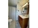 Clean bathroom with wood vanity, large mirror and shower at 6704 Hoemi Ct, North Port, FL 34287